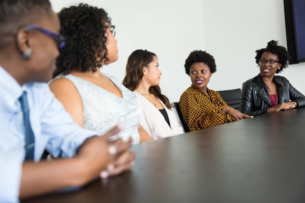 Colleagues in conversation around a meeting table