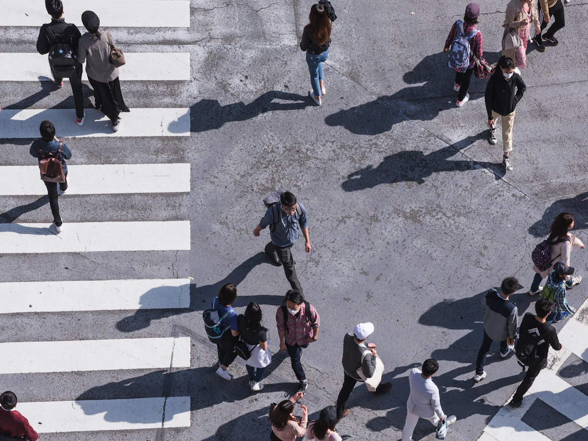 Aerial view of pedestrians crossing a busy city intersection
