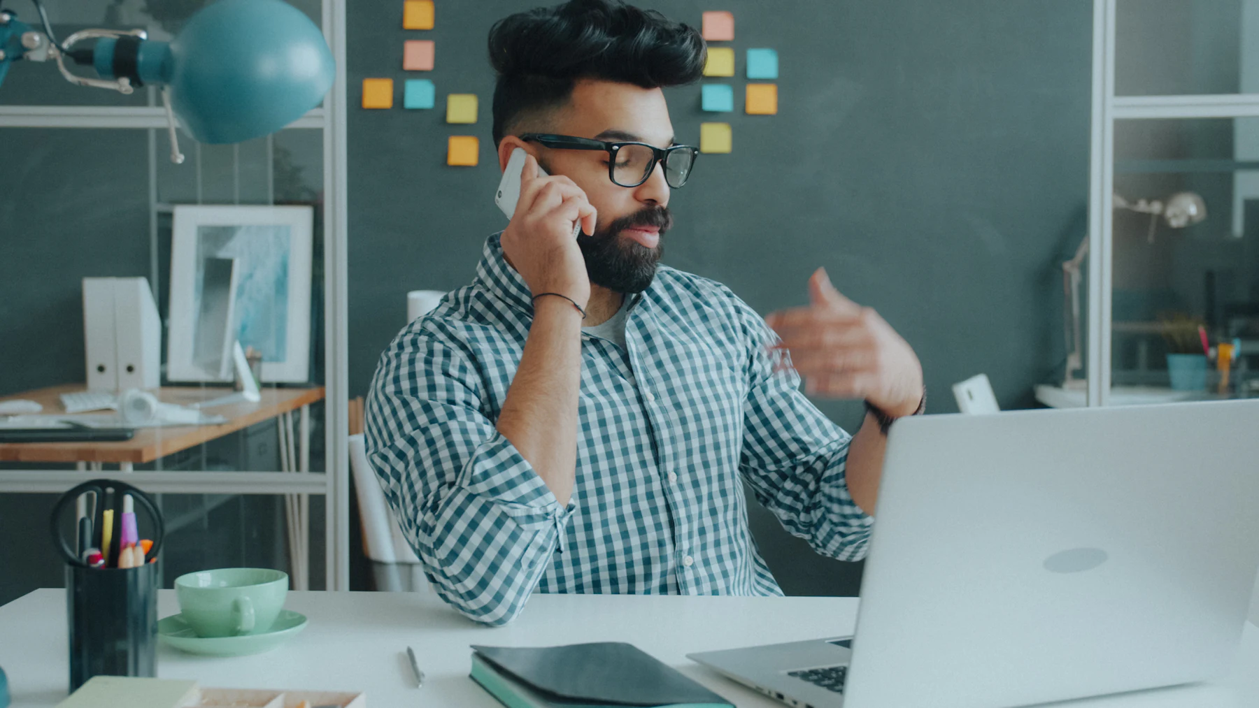 Sales representative on a phone call at his desk