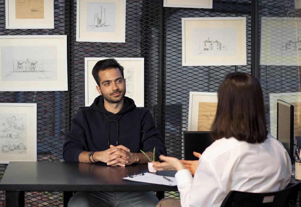 Candidate speaking with an interviewer across a table